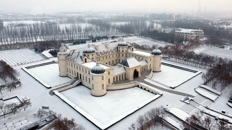 Aerial view of the château covered in snow