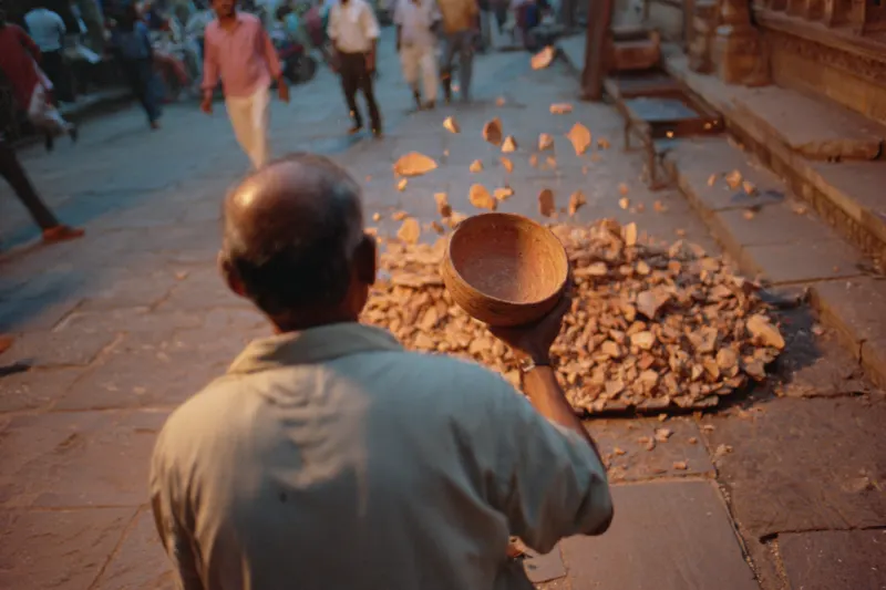 A man throwing a clay bowl to the ground in bowl-smashing wine
