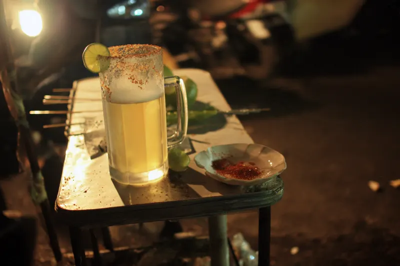 Chilli Lime Lager: lager in a glass mug with a chilli salt rim and lime