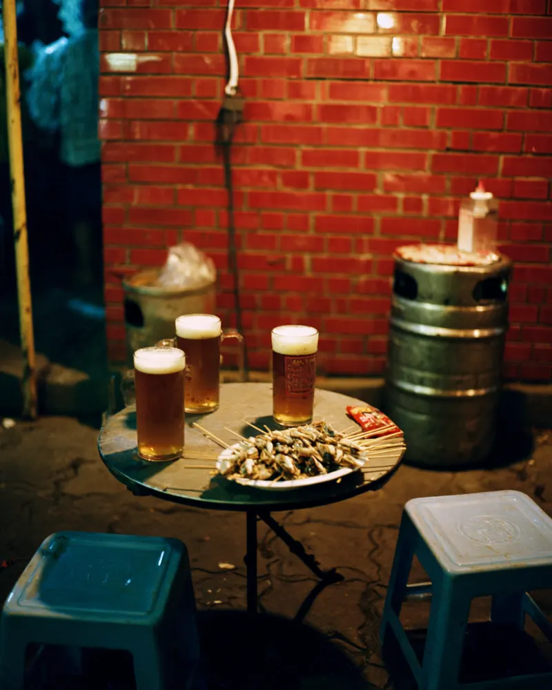 Mugs of draft beer with clams on a street stall table in Qingdao