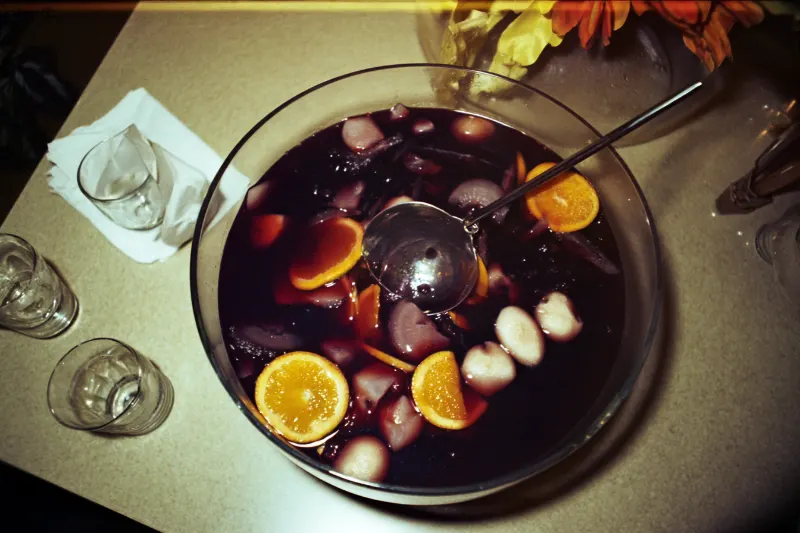 Silk Road Punch: red wine punch with orange slices and lychees in a glass bowl