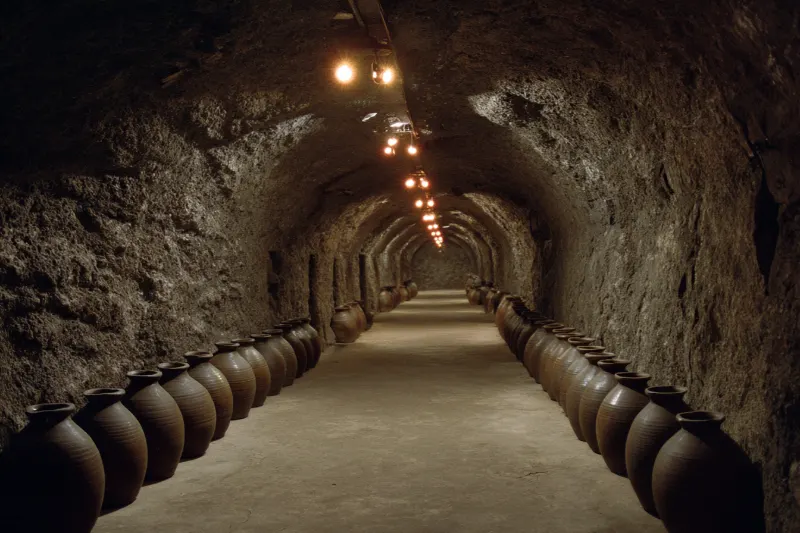 Clay jars of Matsu old wine ageing in a granite tunnel