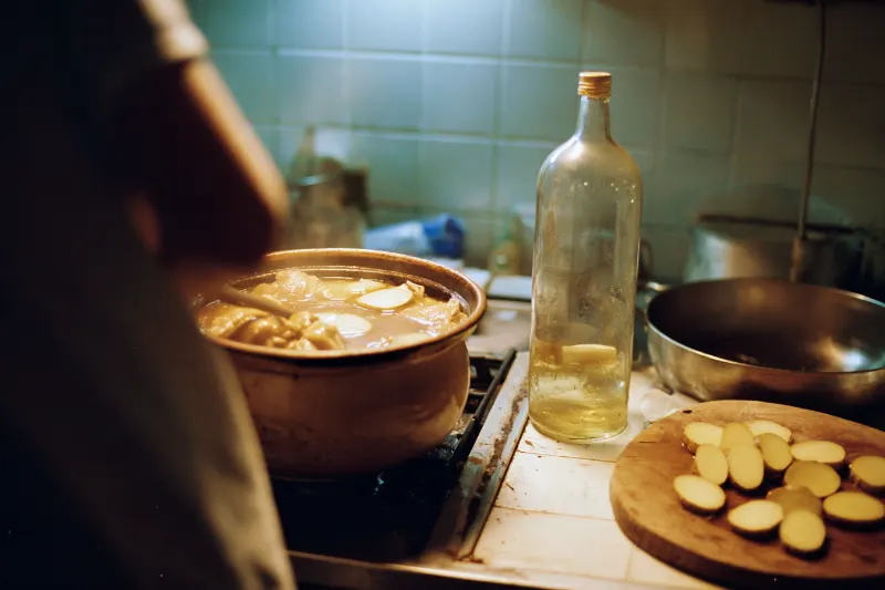 Sesame oil chicken cooking with rice wine in a Taiwanese home kitchen